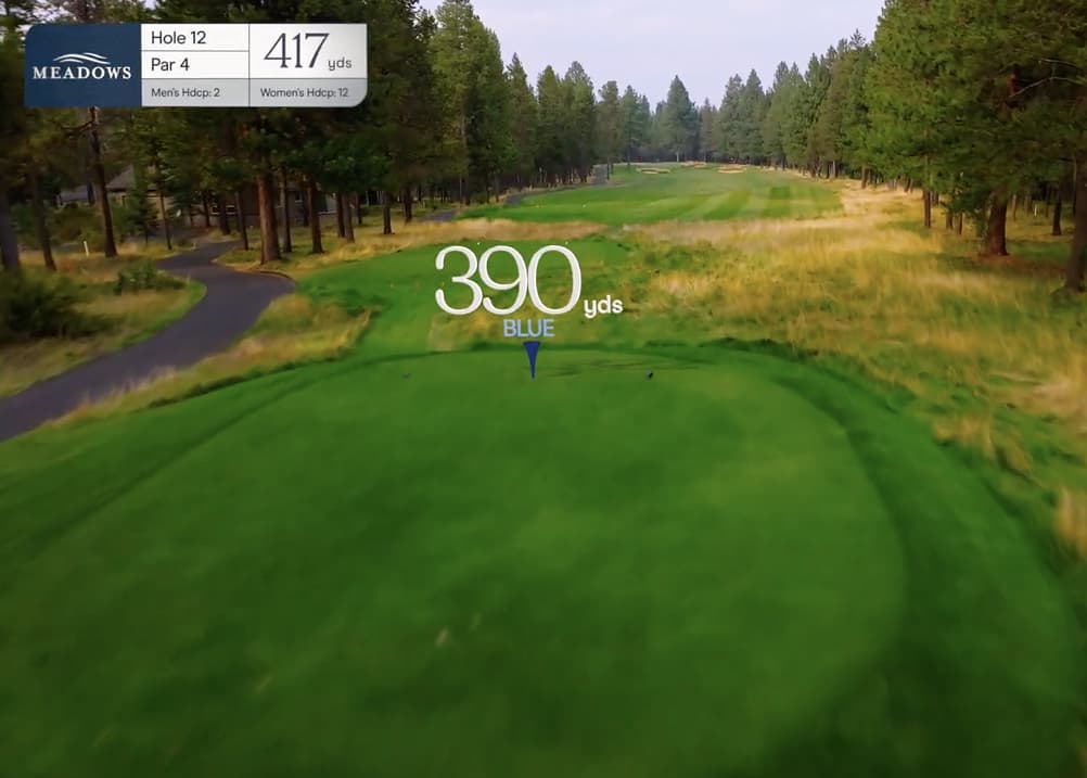 Aerial tee shot view of Meadows Golf Course Hole 12, a 417-yard par 4 featuring a tree-lined fairway and a gently narrowing landing area.