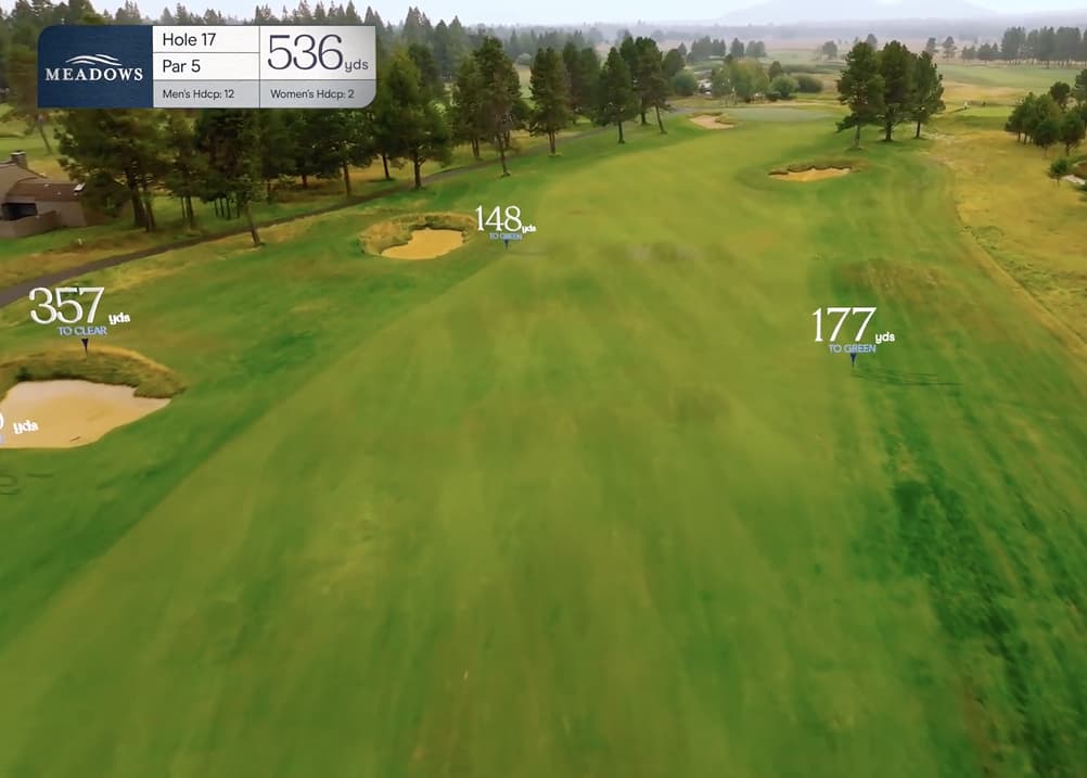 Aerial fairway view of Meadows Golf Course Hole 17, a 536-yard par 5 with a wide landing area, scattered bunkers, and open landscape leading toward a distant green.