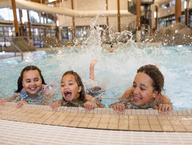three little kids splashing at the cove