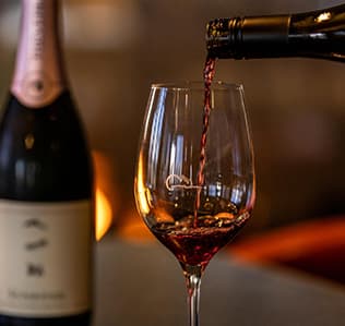 Close up of red wine being poured into a wine glass